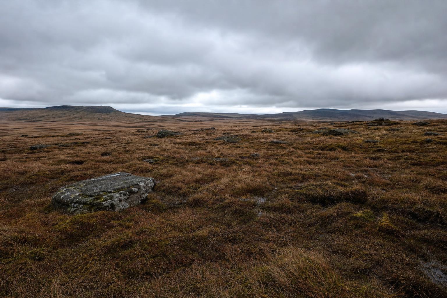 Peaty gritstone plateau of Kinder Scout under an open sky