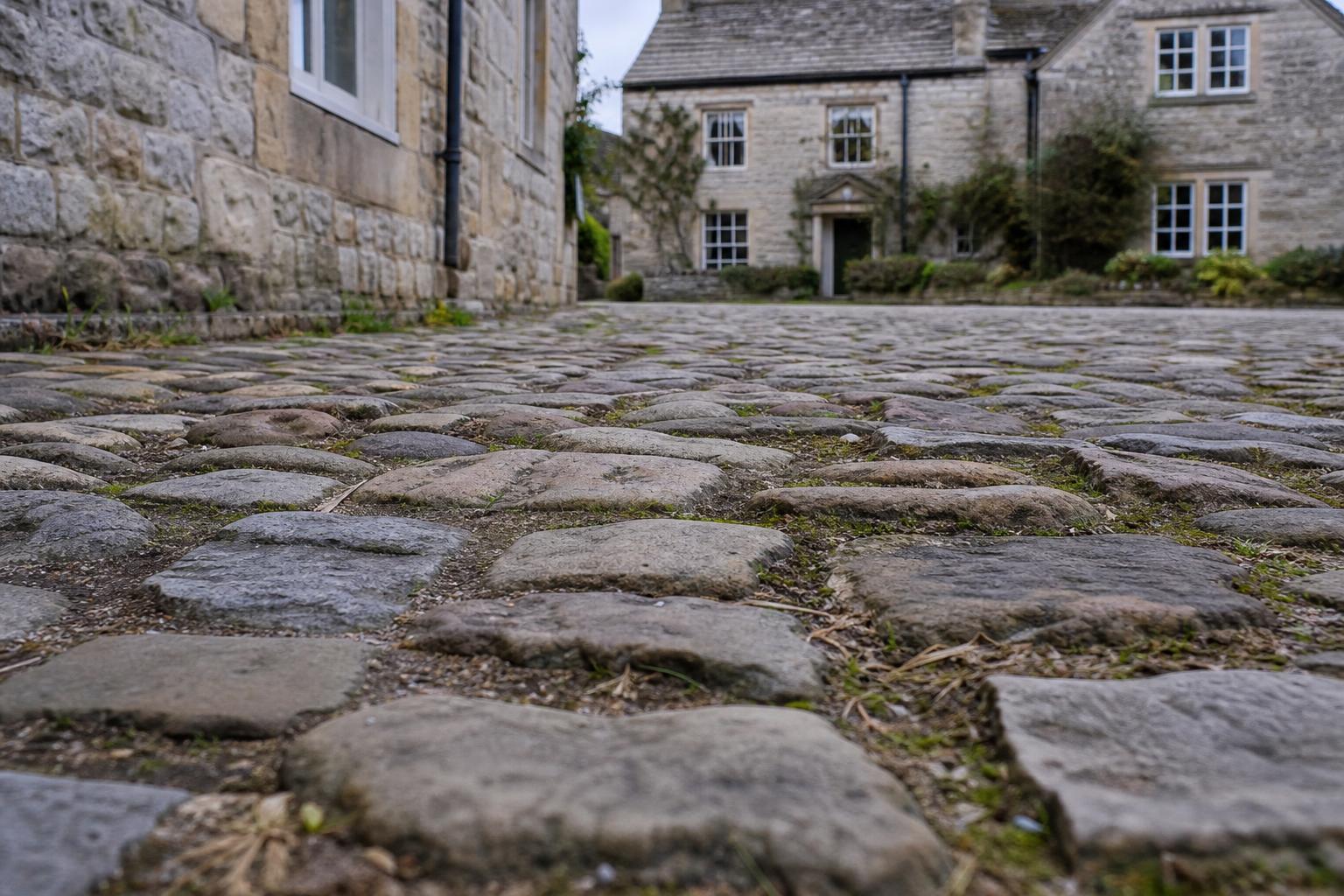 Cobbled square lined with stone shopfronts in Grassington